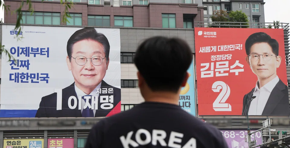 Banners of Liberal front runner Lee Jae-myung (left) and conservative candidate Kim Moon-soo.