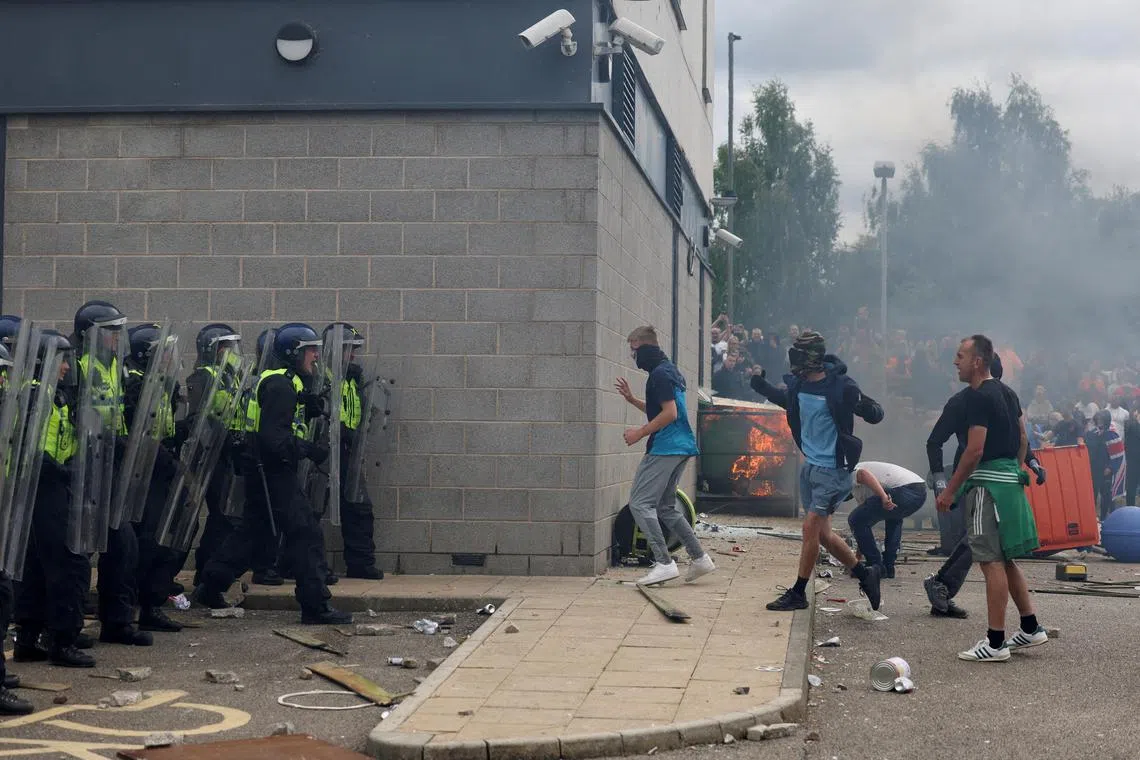Demonstrators clash with police officers during an anti-immigration protest in Britain on Aug 4. Fostering better understanding among people is essential to prevent social tensions from boiling over.
