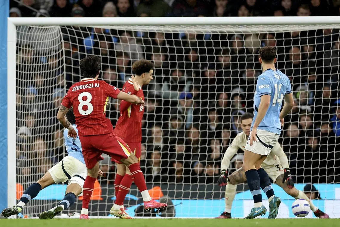 (Second from left) Dominik Szoboszlai of Liverpool scores the second goal during the English Premier League match between Manchester City and Liverpool, Manchester, Britain, Feb 23, 2025.  