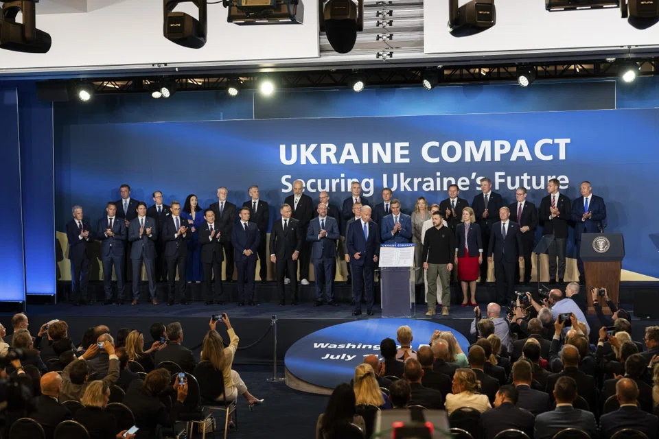 US President Joe Biden and Ukraine President Volodymyr Zelenskyy pose with the Ukraine Compact and Nato leaders in Washington, D.C., July 11, 2024. 