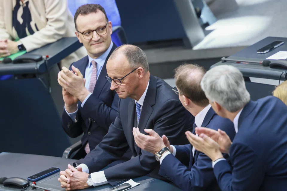 Germany's newly elected Chancellor and Christian Democratic Union party chairman Friedrich Merz (second  from left) receives applause after the second round of voting at the Bundestag in Berlin.