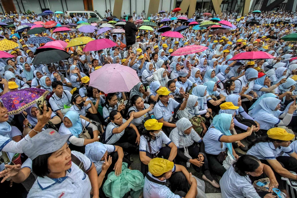 Textile factory workers listening to a farewell speech during the mass layoffs in Sukoharjo, Central Java, on Feb 28, after Indonesia's Supreme Court declared the textile giant Sritex bankrupt.