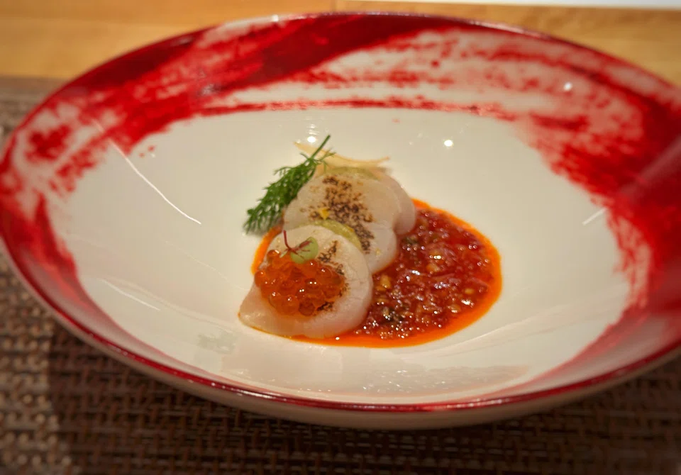 Seared scallops in spicy sweet-sour sauce.