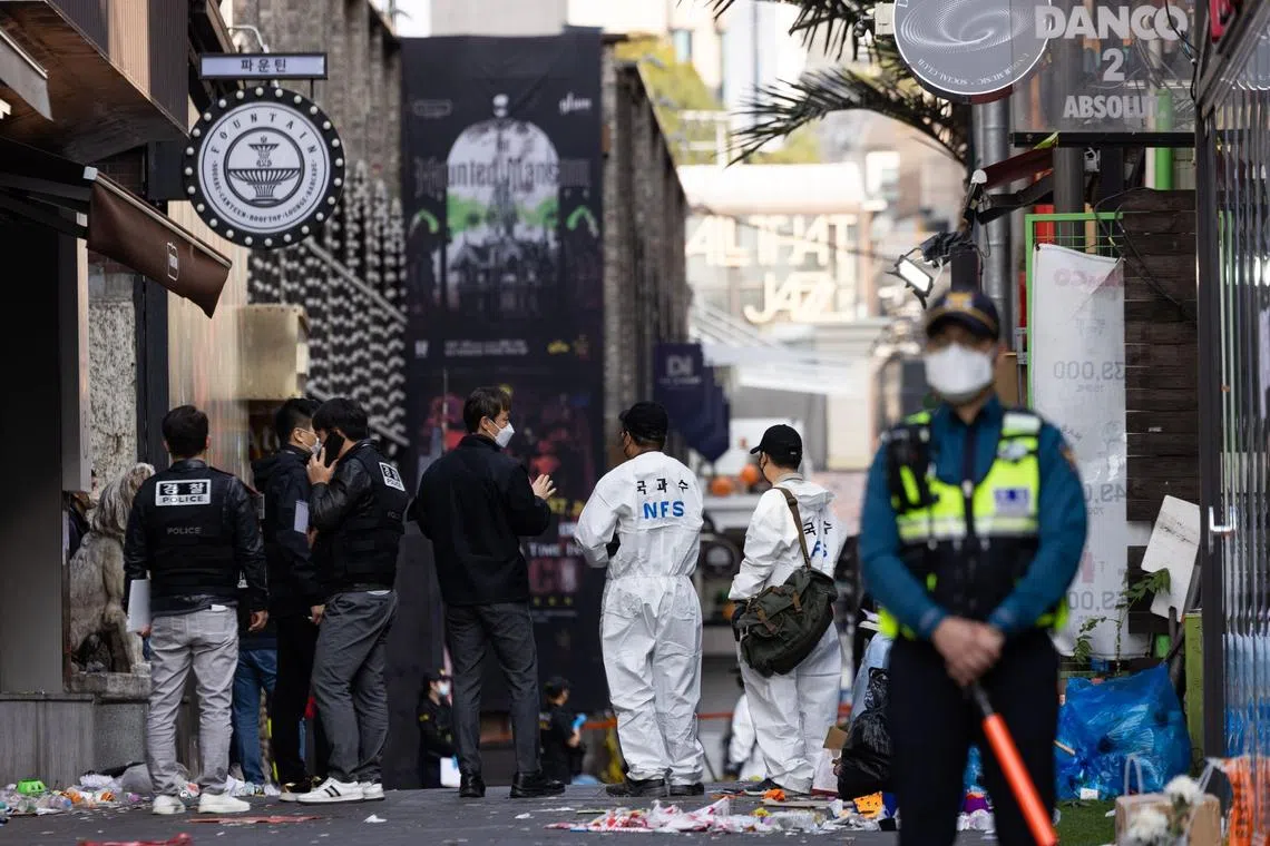 Crime scene and forensic investigators at the site of a deadly crowd crush during Halloween festivities in the Itaewon district. Police blame the tragedy on negligence.