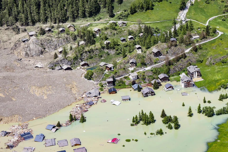 An aerial view shows the destruction of Blatten village in Switzerland after a massive avalanche triggered by the collapse of the Birch Glacier. As climate change accelerates and extreme weather events become more common, governments that delay taking action now will face a far more challenging transition down the line.