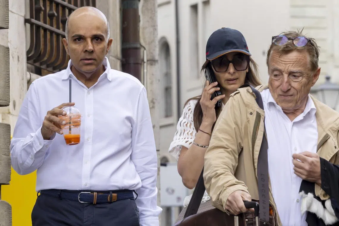 Ajay Hinduja (left) and his wife Namrata arrive with their lawyer Robert Assael at the court house for the resumption day of the trial against members of Indian billionaire family Hinduja, charged with human traficking and usury, in Geneva, Switzerland.