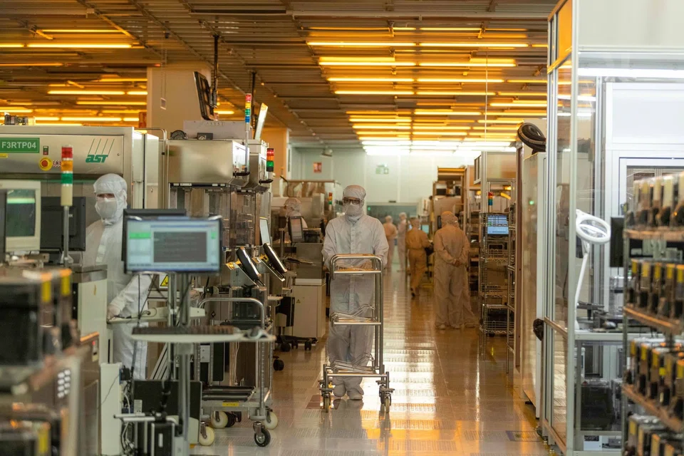 Workers in the clean room for silicon semiconductor wafer manufacture at the Newport Wafer Fab, owned by Nexperia Holding BV, in Newport, UK, August 2022. 