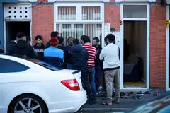 Members of the local community stand outside the family home of Ramesh Viswashkumar, a British survivor of the London-bound Air India aircraft crash near Ahmedabad Airport in India, Leicester, Britain, June 12, 2025.  