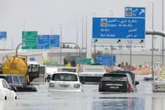 Abandoned vehicles on a flooded highway after a rainstorm in Dubai.