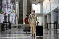 Travellers arrive at the Hong Kong International Airport on the first day Covid-19 hotel quarantine was scrapped, Hong Kong, China, Sept 26, 2022. 