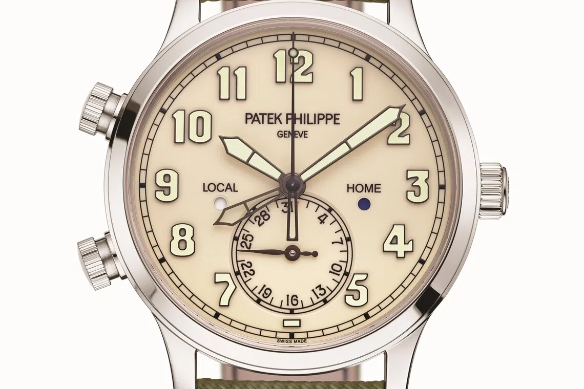 The new Patek Philippe Calatrava Pilot Travel Time 5524G-010 boasts an elegant vintage-style ivory lacquered dial, as well as a khaki green composite-material strap with fabric pattern.  