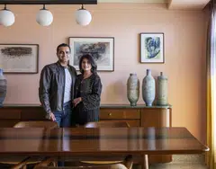 Vir and Simran Kotak at home posing against rare watercolours by the late New York-based printmaker Krishna Reddy, known for inventing the multi-viscosity printmaking technique.