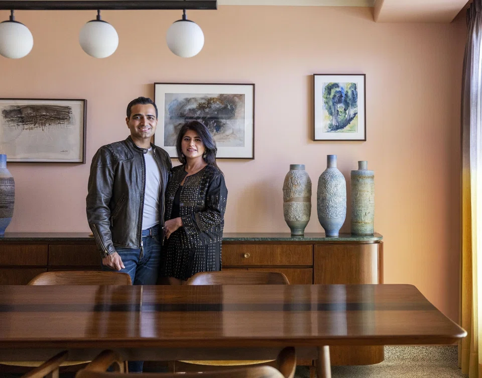 Vir and Simran Kotak at home posing against rare watercolours by the late New York-based printmaker Krishna Reddy, known for inventing the multi-viscosity printmaking technique.