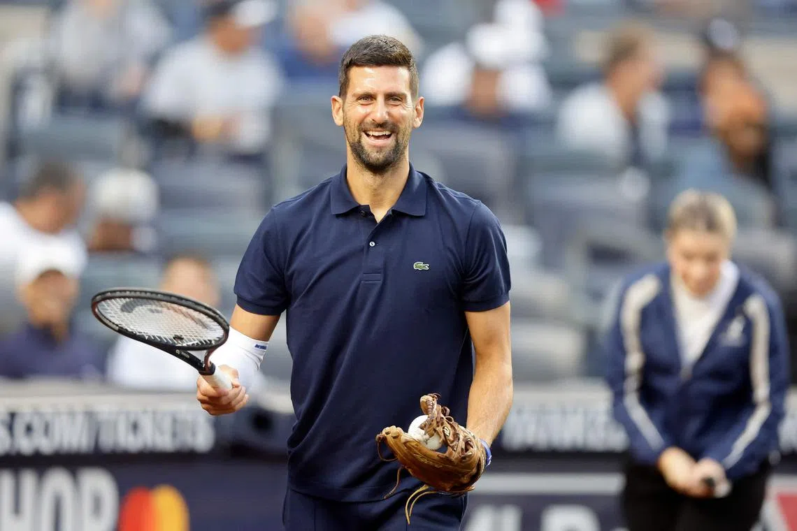 Novak Djokovic preparing to throw the ceremonial first pitch prior to a baseball game in New York on Aug 21. The 38-year-old is chasing his 25th Grand Slam title at the US Open.