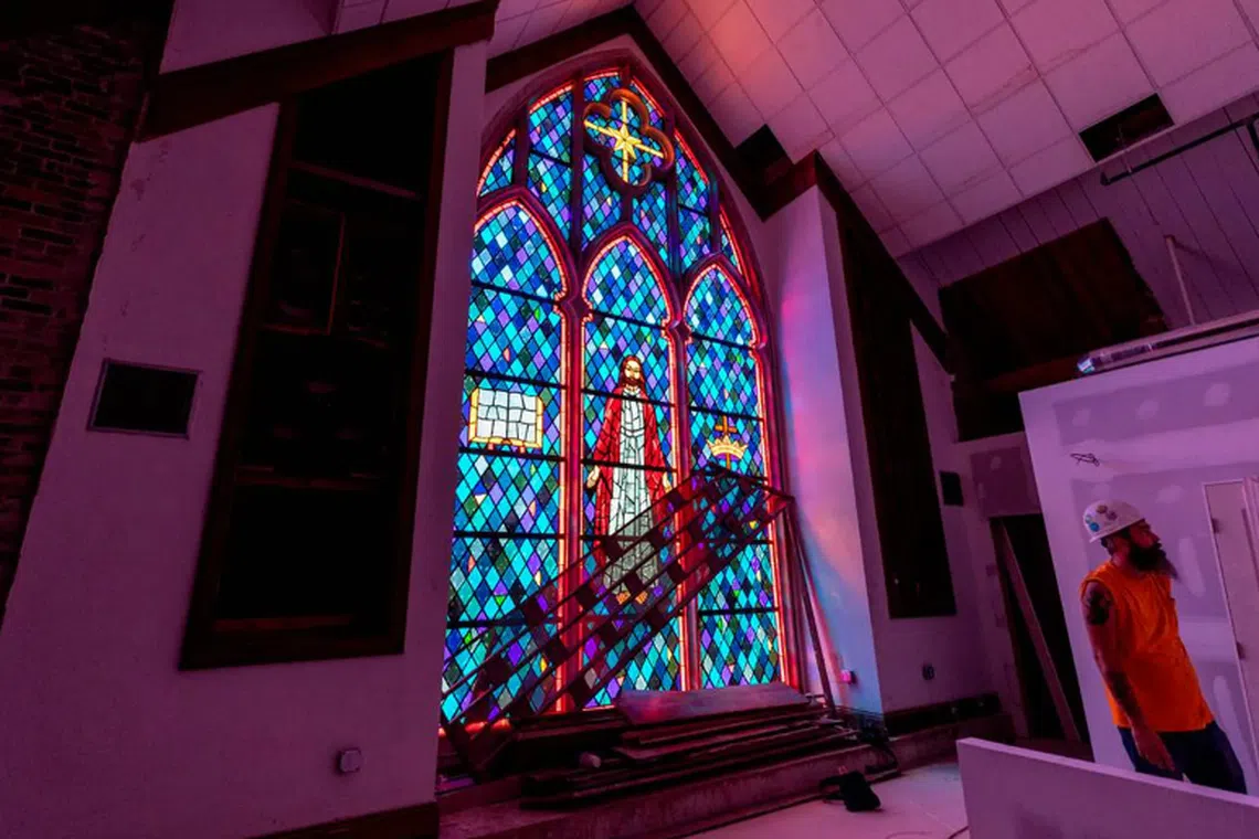 Workers in Columbia, South Carolina, transform the former Rosewood Baptist Church in three apartment buildings in 2022. 