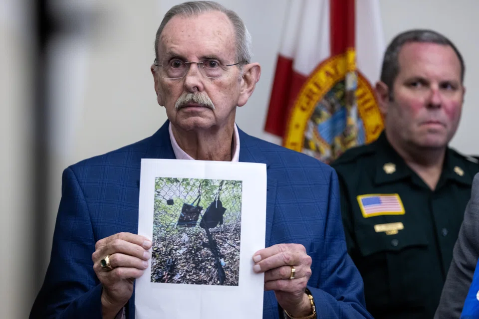 West Palm Beach Sheriff Task Force Contact Sheriff Ric L. Bradshaw shows a picture of an AK-style rifle with a scope, and bags found by the Secret Service at the Trump International Golf Club in in West Palm Beach, Florida, Sept 15, 2024.