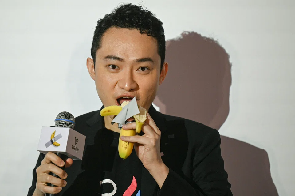 Chinese-born crypto founder Justin Sun eats a banana artwork composed of a fresh banana stuck to a wall with duct tape in Hong Kong. He bought the provocative work of conceptual art by Italian artist Maurizio Cattelan at a New York auction for US$6.2 million.