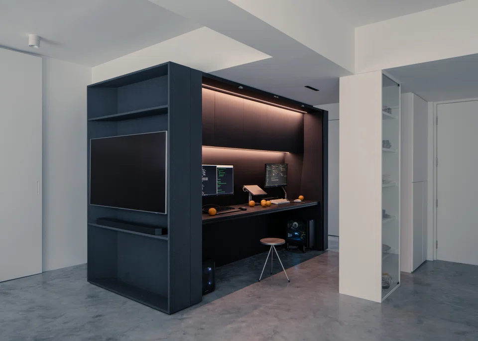 Sliding panels contain the television, study area and storage spaces.