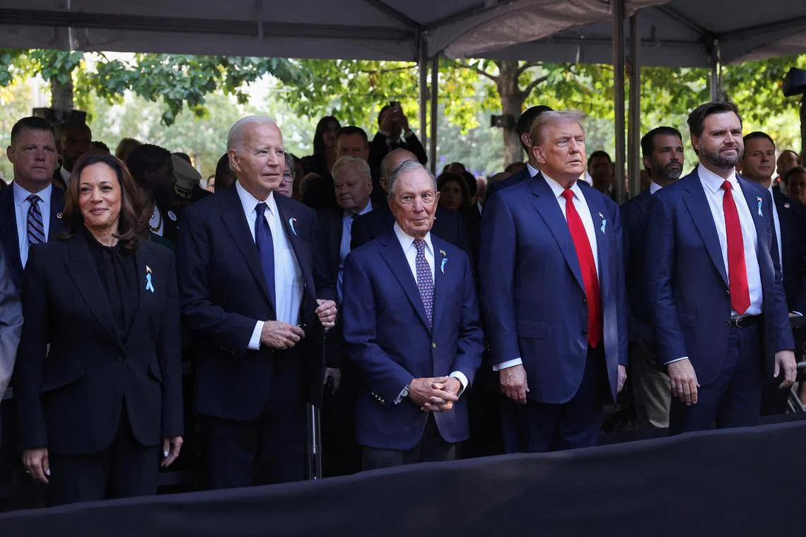 (From left) Democratic presidential nominee and Vice-President Kamala Harris, US President Joe Biden, former New York Mayor Michael Bloomberg, Republican presidential nominee and former US President Donald Trump and Republican US vice-presidential nominee Senator JD Vance  stand on the day of a ceremony marking the 23rd anniversary of the September 11, 2001 attacks on the World Trade Center at the 9/11 Memorial and Museum in the Manhattan borough of New York City.