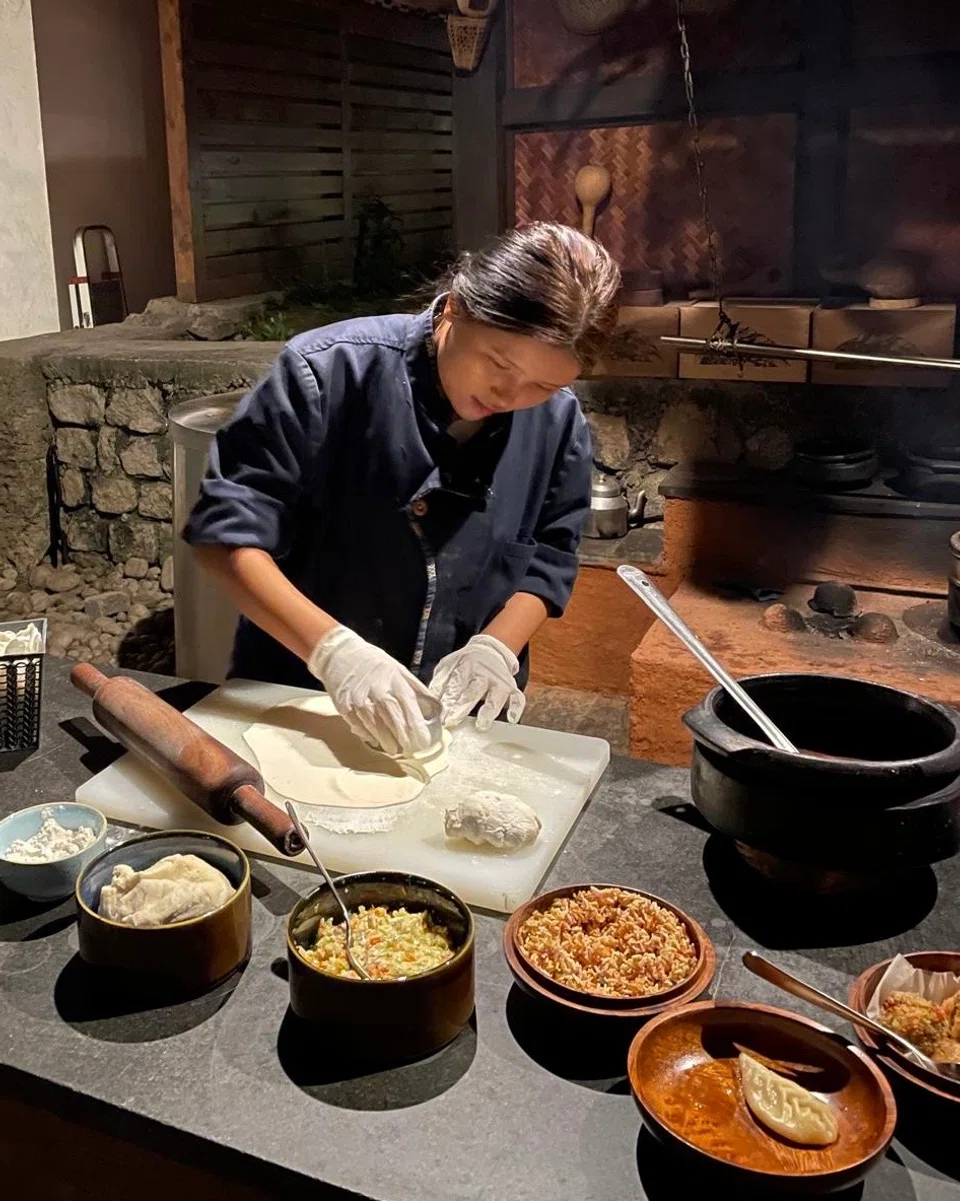 At &amp;Beyond Punakha River Lodge, andBeyond employee Dorji makes dumplings for guests.