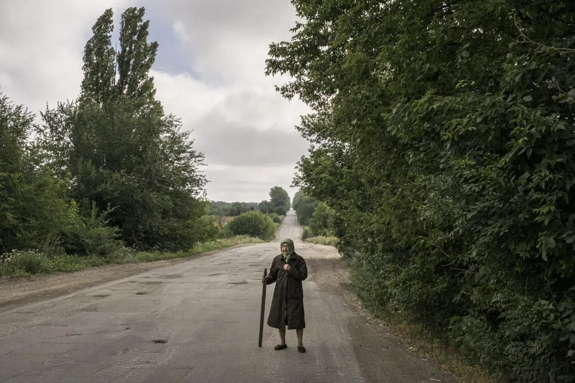 An elderly Ukrainian villager on a road on the outskirts of Dibrova on July 23, 2022. The relative balance of risks between demography and climate is changing.