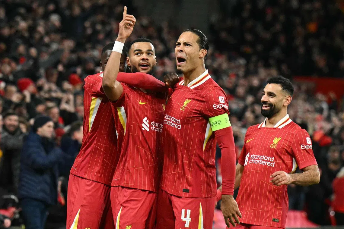 Liverpool striker Cody Gakpo (second from left) celebrates with Virgil van Dijk after scoring against Real Madrid in the Champions League on Nov 27, 2024.