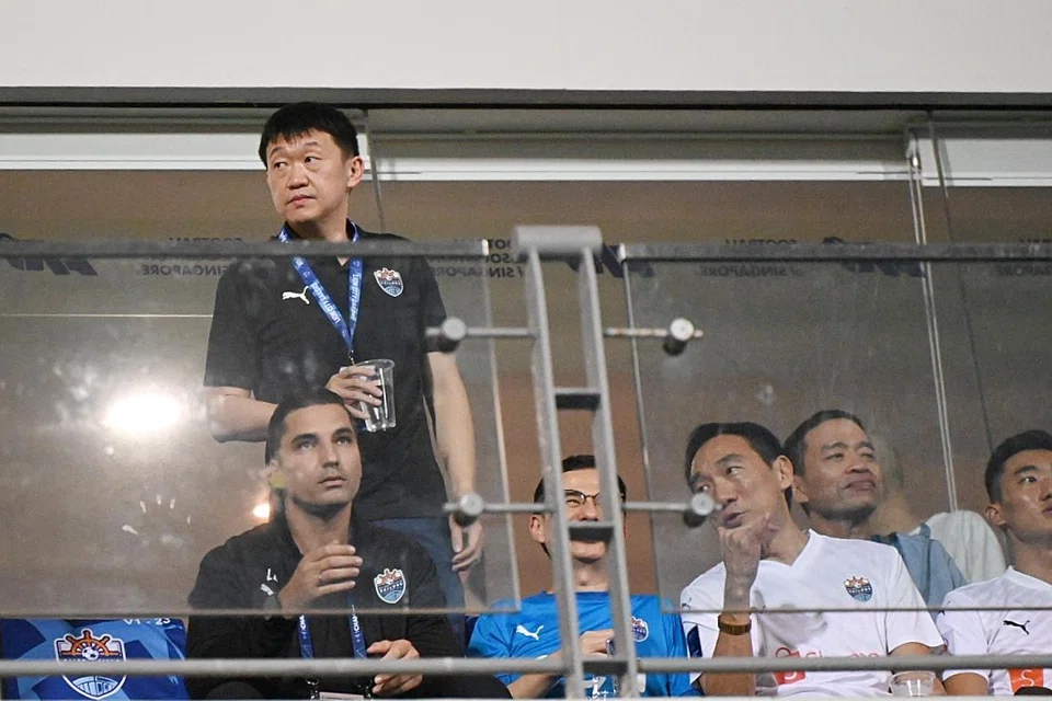Tech billionaire Forrest Li (standing) watching the Lion City Sailors at Jalan Besar Stadium. on Mar 12. 