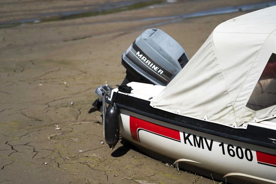 Boats are lying in the mud in the harbour in Beusichem, the Netherlands, 03 August 2022. The Netherlands declared an official water shortage on Wednesday (Aug 3) as the low-lying “land of water” was hit by Europe’s sweltering summer.