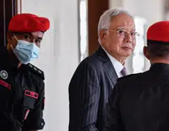 High Court judge Ahmad Fairuz Zainol Abidin ruled that Najib (top) breached his fiduciary duties, abused his position as prime minister, and misappropriated SRC funds for personal gain.