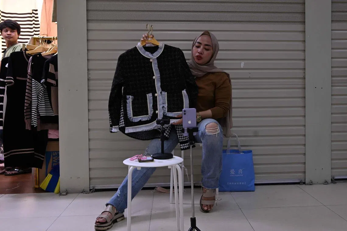 A vendor using the TikTok app to sell clothes in a market in Jakarta. Indonesia has one of the largest social media user penetrations in the Asia-Pacific - a factor that must be considered by businesses looking to tap into the vast opportunities that the region presents. 