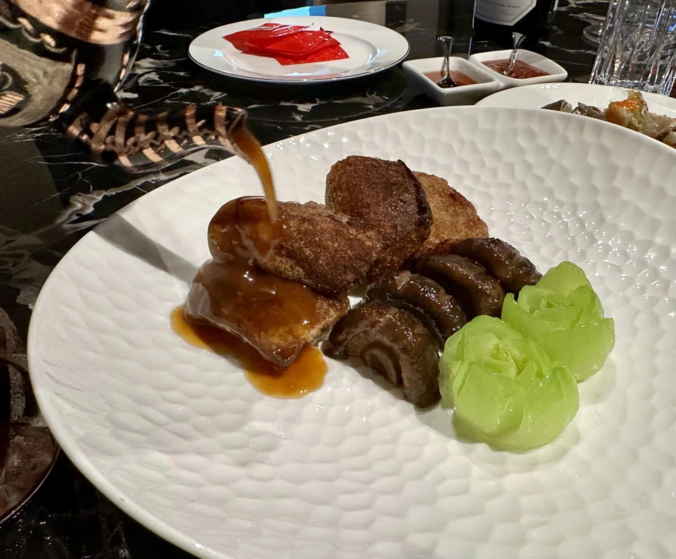Crispy fried sea cucumber in abalone sauce.