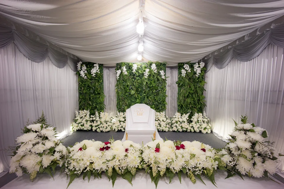 A set up with lush greenery by Direct Funeral Services.