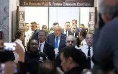 Former US President Donald J. Trump (centre) walks out of the courtroom after attending the first day of his civil fraud trial in New York, New York, Oct 2, 2023. 