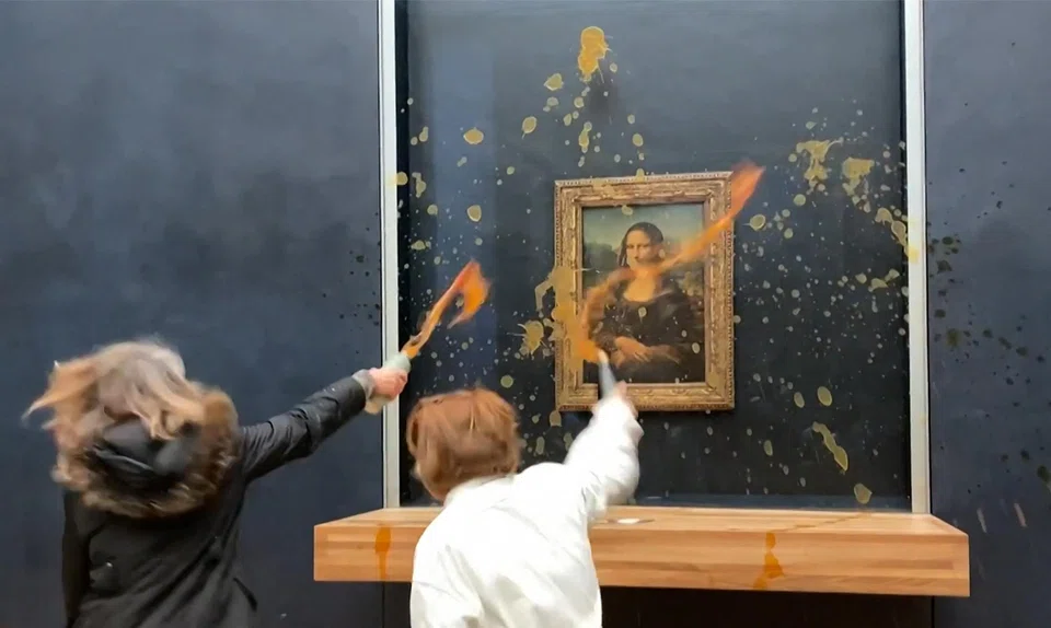Two environmental activists from the collective Riposte Alimentaire hurling soup at Leonardo Da Vinci's "Mona Lisa" on Jan 28, 2024.