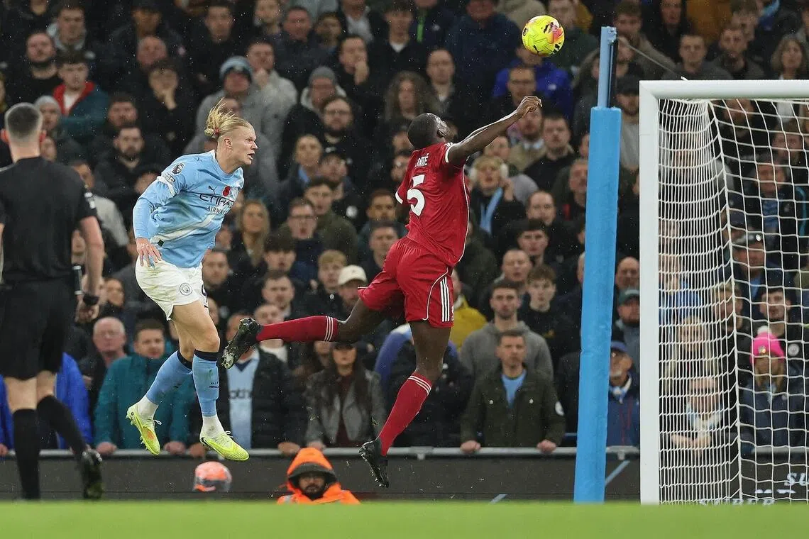 Manchester City's Erling Haaland (left) scores the first goal during the English Premier League match between Manchester City and Liverpool FC, Manchester, Britain, Nov 9, 2025.  