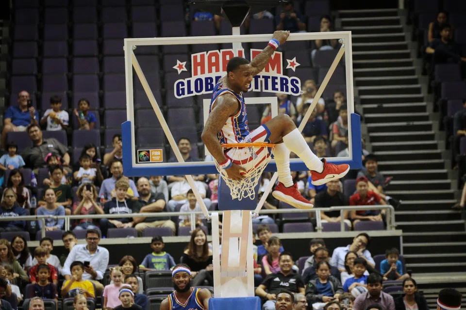 The Harlem Globetrotters’ Bull Bullard perching atop the basket during the team's previous visit to Singapore in April 2019.