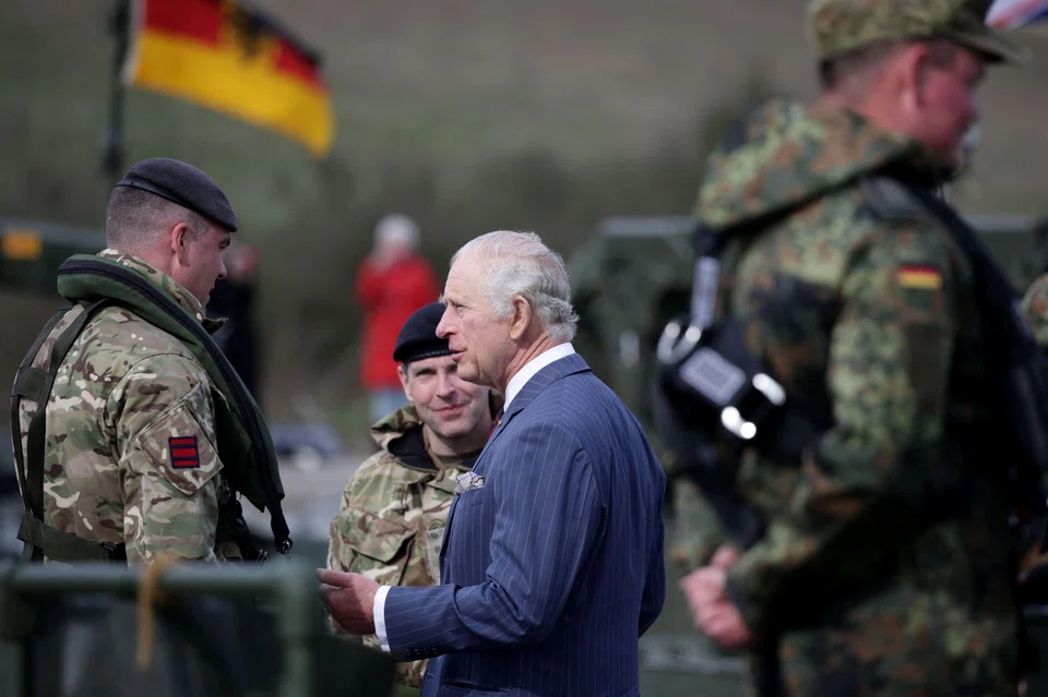 Britain's King Charles meeting soldiers during his visit to the 130th German-British Pioneer Bridge Battalion military unit in Finowfurt, eastern Germany, on Mar 30, 2023. 