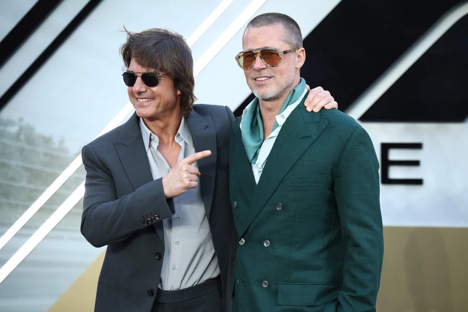 Brad Pitt (right) poses with Tom Cruise at the European premiere of "F1: The Movie" in London, Britain, June 23, 2025. 