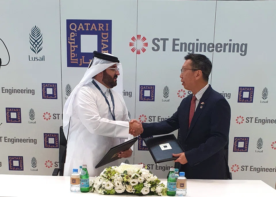 Qatari Diar's chief executive Ali Mohamed Al-Ali (left) and ST Engineering's president of urban solutions Chew Men Leong at the contract signing in Qatar. 