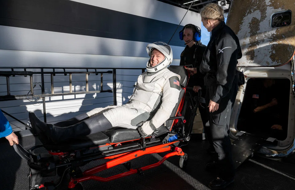 Nasa astronaut Butch Wilmore is helped out of a SpaceX Dragon spacecraft onboard the SpaceX recovery ship Megan.     