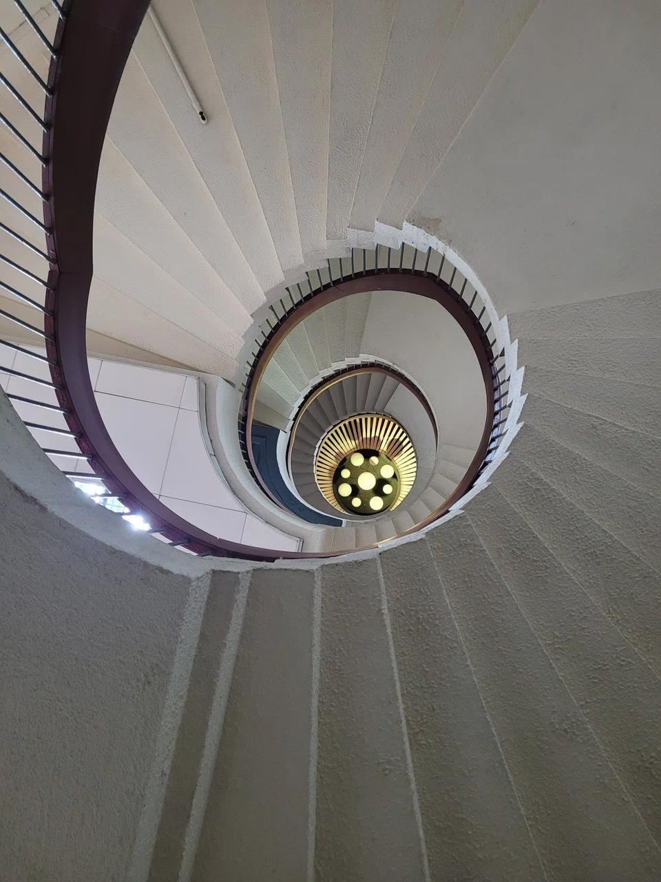 Golden Mile Tower's Instagram-friendly spiral stairs viewed from the bottom.