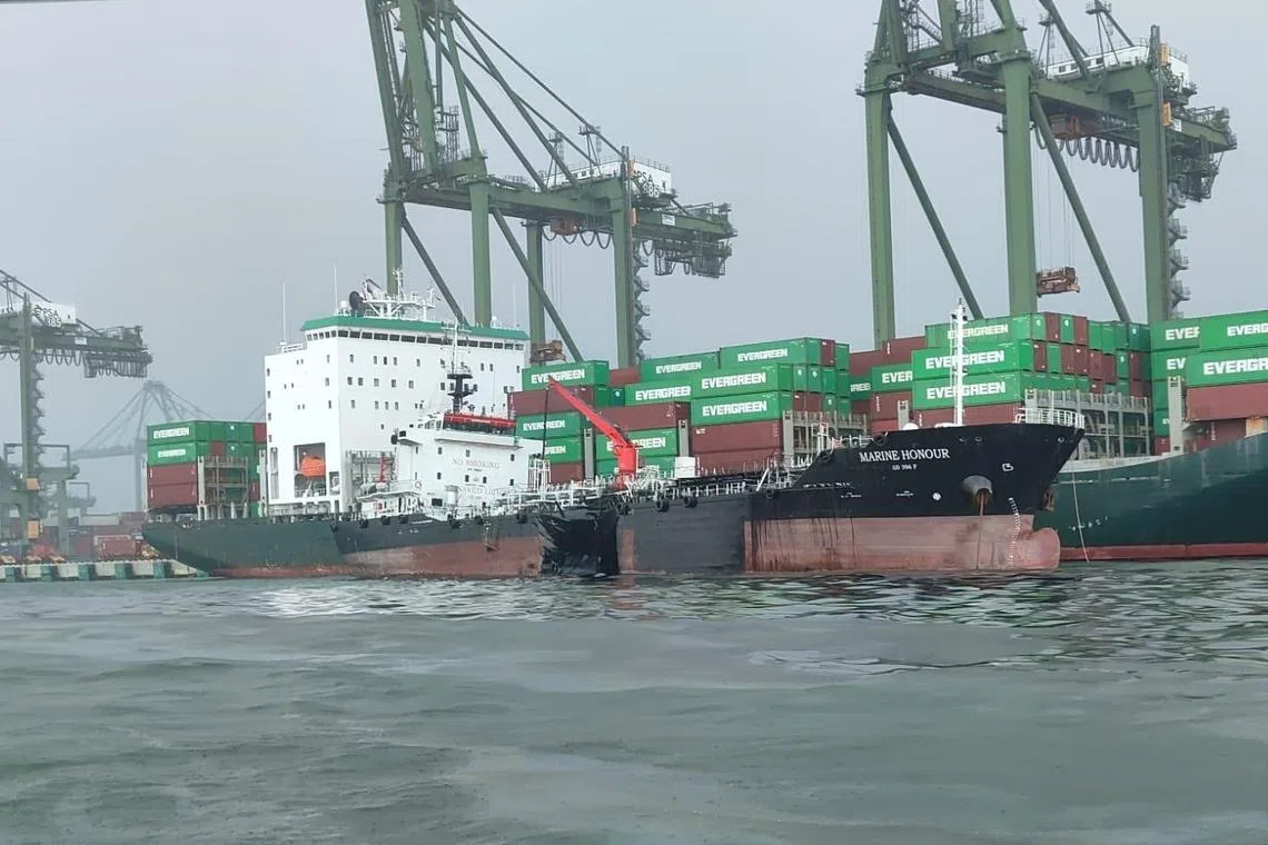 One of the Marine Honour's oil cargo tanks was ruptured on Friday. MPA patrol craft were immediately deployed to spray dispersants on the oil spill. 