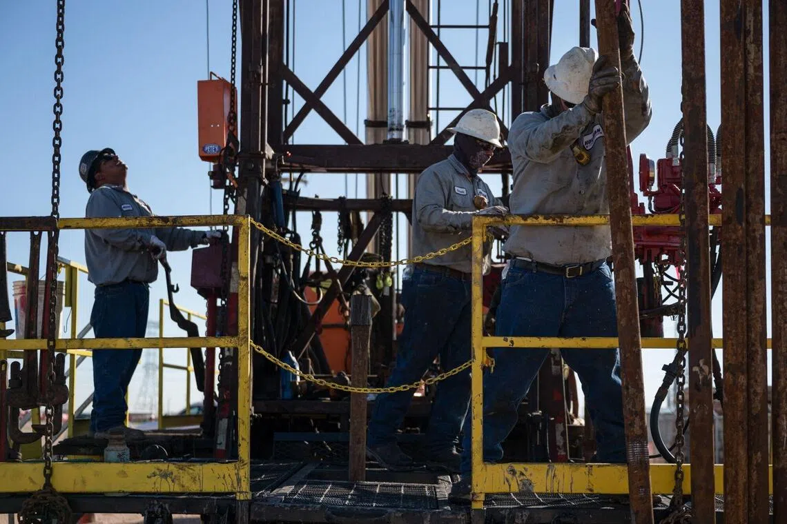 An oilfield crew, contracted by the Railroad Commission of Texas (RRC), works a service rig during a state-funded oil well plugging operation in Midland, Texas, US, on Thursday, Sept. 25, 2025. Oil fluctuated in choppy trading as tensions between Russia and NATO intensified, with European leaders warning the Kremlin that Western military alliance is ready to respond with force to violations of its airspace. Photographer: Eli Hartman/Bloomberg