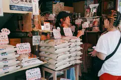 A rice mill employee serves a customer in Tokyo, Japan, July 18, 2025. Under a WTO “minimum access” framework introduced in 1995, Japan imports about 770,000 metric tons of rice tariff-free every year. Last fiscal year, the US accounted for 45 per cent of the total.