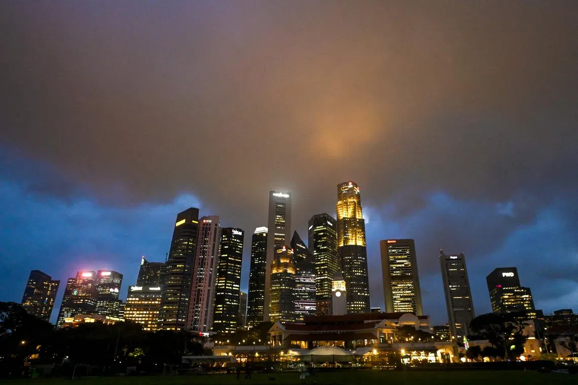 (FILES) Rain clouds hover over the skyline of Singapore on January 14, 2025. Singaporeans vote on May 3, 2025 in an election that will test Prime Minister Lawrence Wong's leadership, as the wealthy city-state faces a turbulent global economy upended by US tariffs. (Photo by Roslan RAHMAN / AFP)