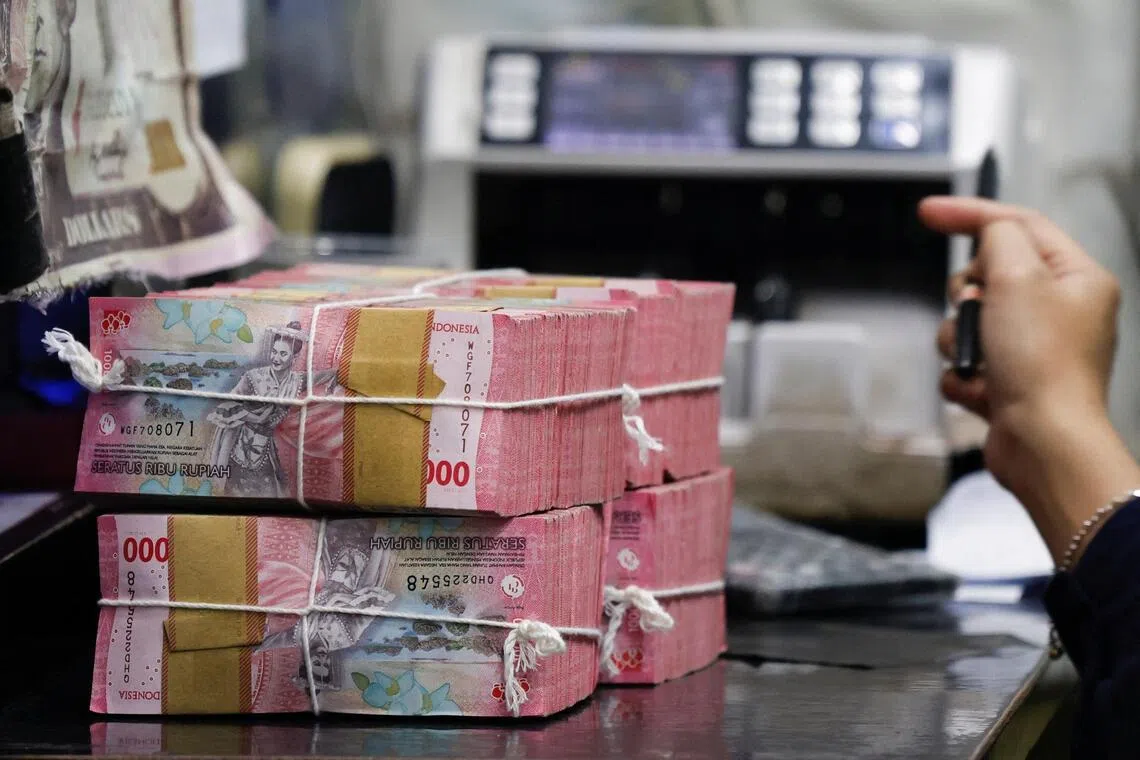 A teller prepares rupiah bank notes at a money changer in Jakarta, Indonesia, January 20, 2026. REUTERS/Ajeng Dinar Ulfiana