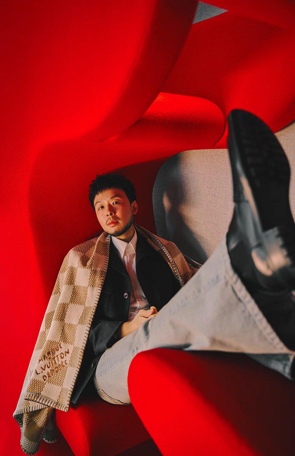 Kiat Lim may be the head honcho, but he's open to disagreements. He wears a grey jacket, denim jeans, wool blanket and cushion from Louis Vuitton.