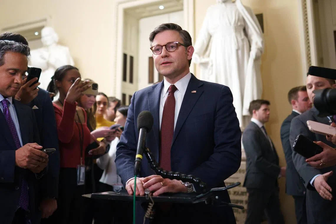 US House Speaker Mike Johnson (centre) speaks to the media after the spending bill was passed in the House of Representatives at the US Capitol in Washington, D.C., Feb 25, 2025. 