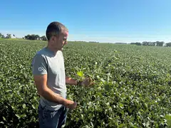 Soybean grower Ryan Frieders stands in a soy field on his farm in Waterman, Illinois, Aug 27, 2025. Harvested soybeans are not moving to export hubs, and instead going to storage, representatives for the two US soy industry groups said.