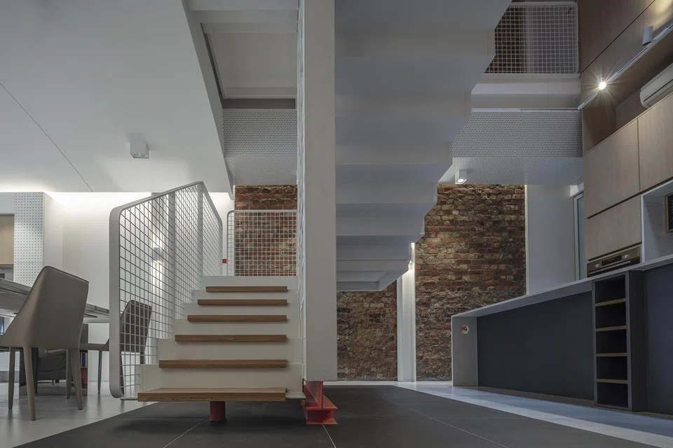 The original brick wall was exposed to highlight the shophouse's heritage.